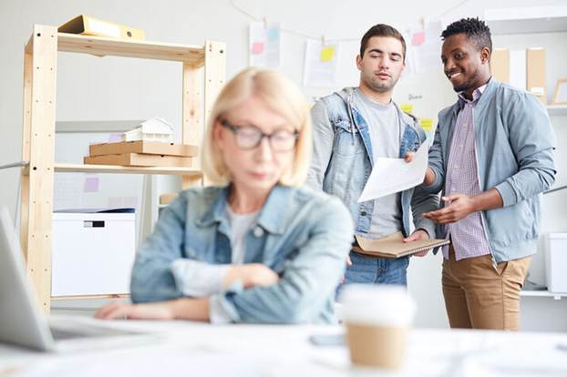 Male coworkers talking behind womans back - Hostile Work Environment